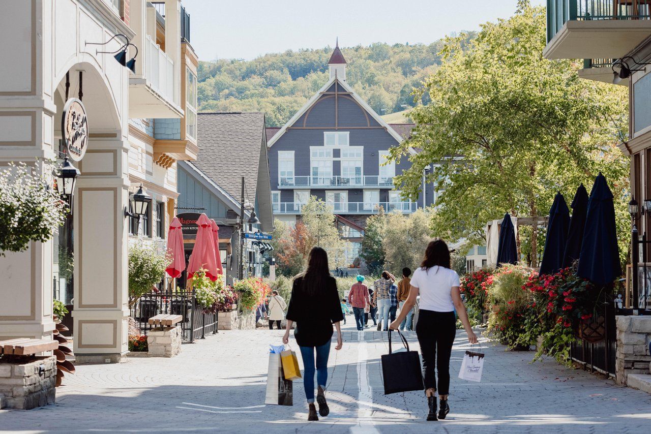 Two ladies shopping in the Village streets in the summer season. 