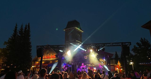 A full audience rocking out around the Subaru Stage for Cory Hotline's headlining performance under the stage lights and night sky.